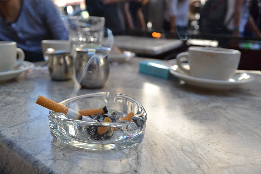 Cigarettes in an ashtray representing the effects of smoking on household air pollution.