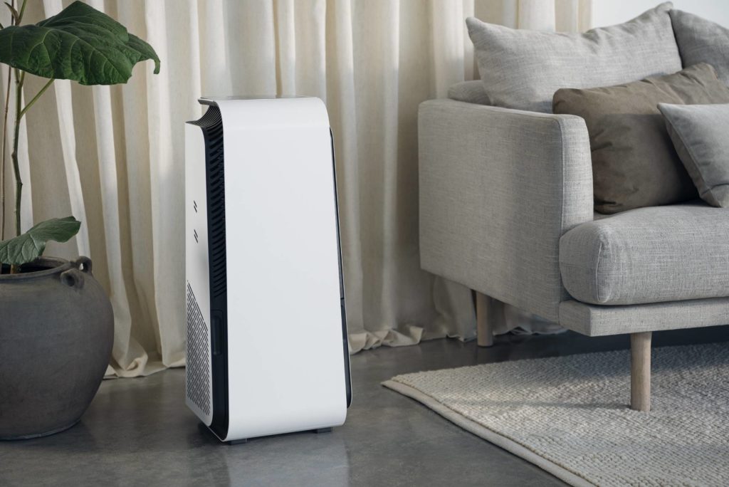 An air purifier in a living room representing good placing of an air purifier.