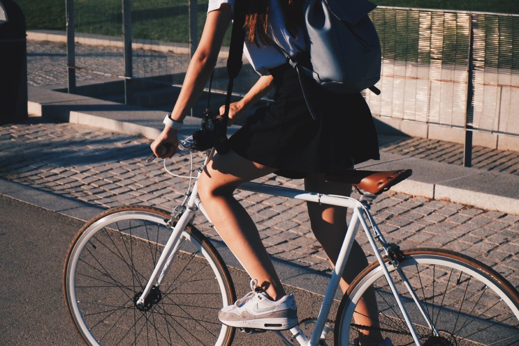 Girl riding a bike as a way to reduce air pollution.