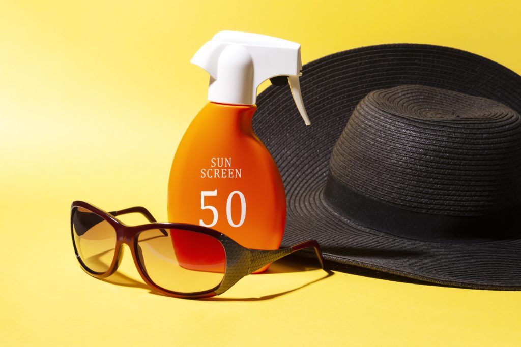 Glasses, sun protection cream, and a hat